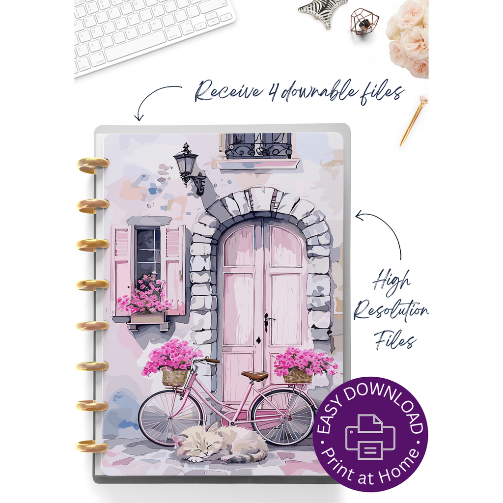 A spiral-bound planner or notebook cover featuring a pastel watercolor illustration of a pink door, pink bicycle with flower baskets, shutters, and a sleeping cat. The product is shown on a white background with decorative props like a keyboard, pen, and flowers, plus promotional text and a purple download badge.
